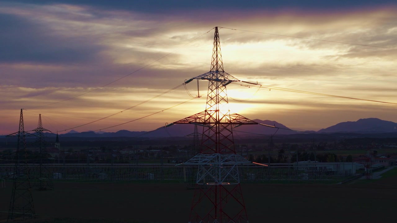 Highvoltage electrical substation switchyard shows transformers and transmission lines during