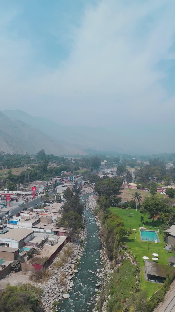 Bright aerial footage of a rural city in Lima, Peru, captured at midday ...