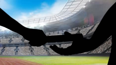 Animation-of-silhouette-of-athlete's-relay-over-sports-stadium