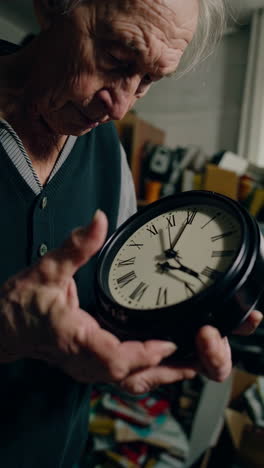 elderly man repairing a vintage clock