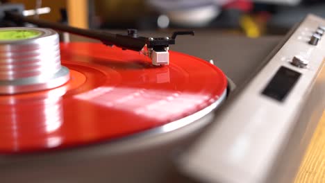 red spinning vinyl plate on a turntable