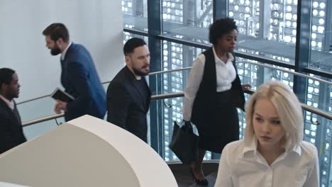 businesspeople walking up and down staircase