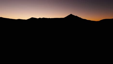 the silhouette of lone mountain in big sky, montana at dusk