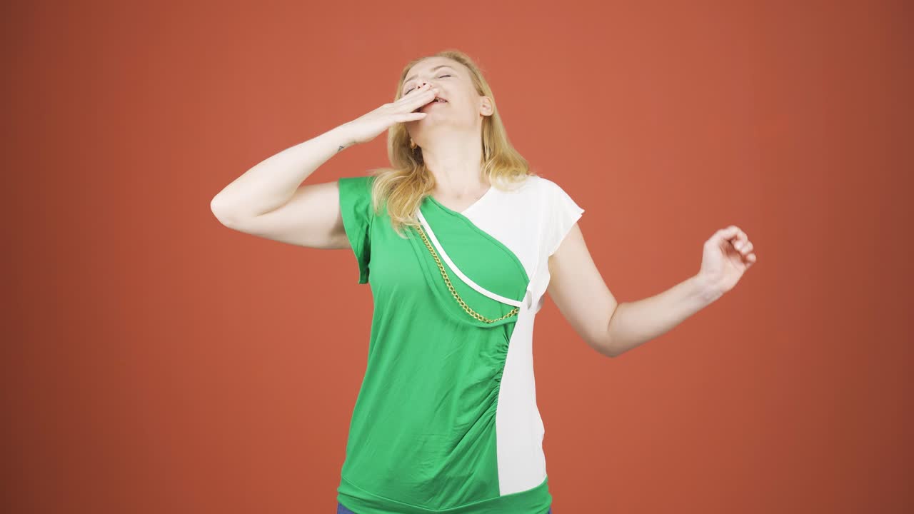 Sleepy woman yawns.