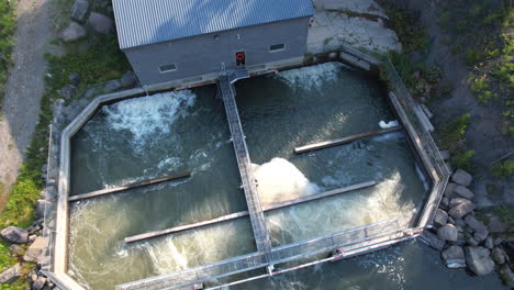 a small hydro electric plant creating and generating electricity at a dam in island park