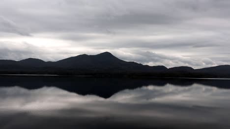 Moving-clouds-over-mountain-and-lake