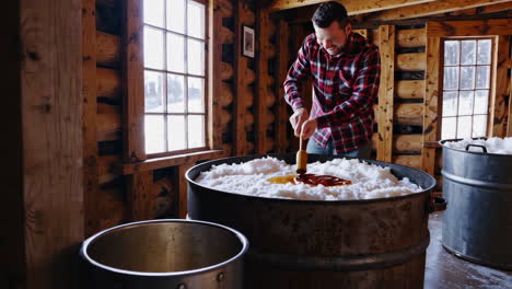 making traditional maple syrup taffy on snow in a sugar shack