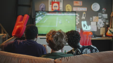 friends watching soccer match on tv and high-fiving with foam fingers at home