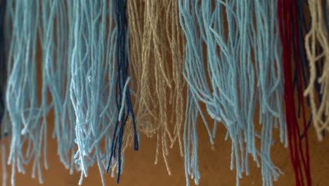 Hanging-Blue-and-Beige-Threads-for-Weaving