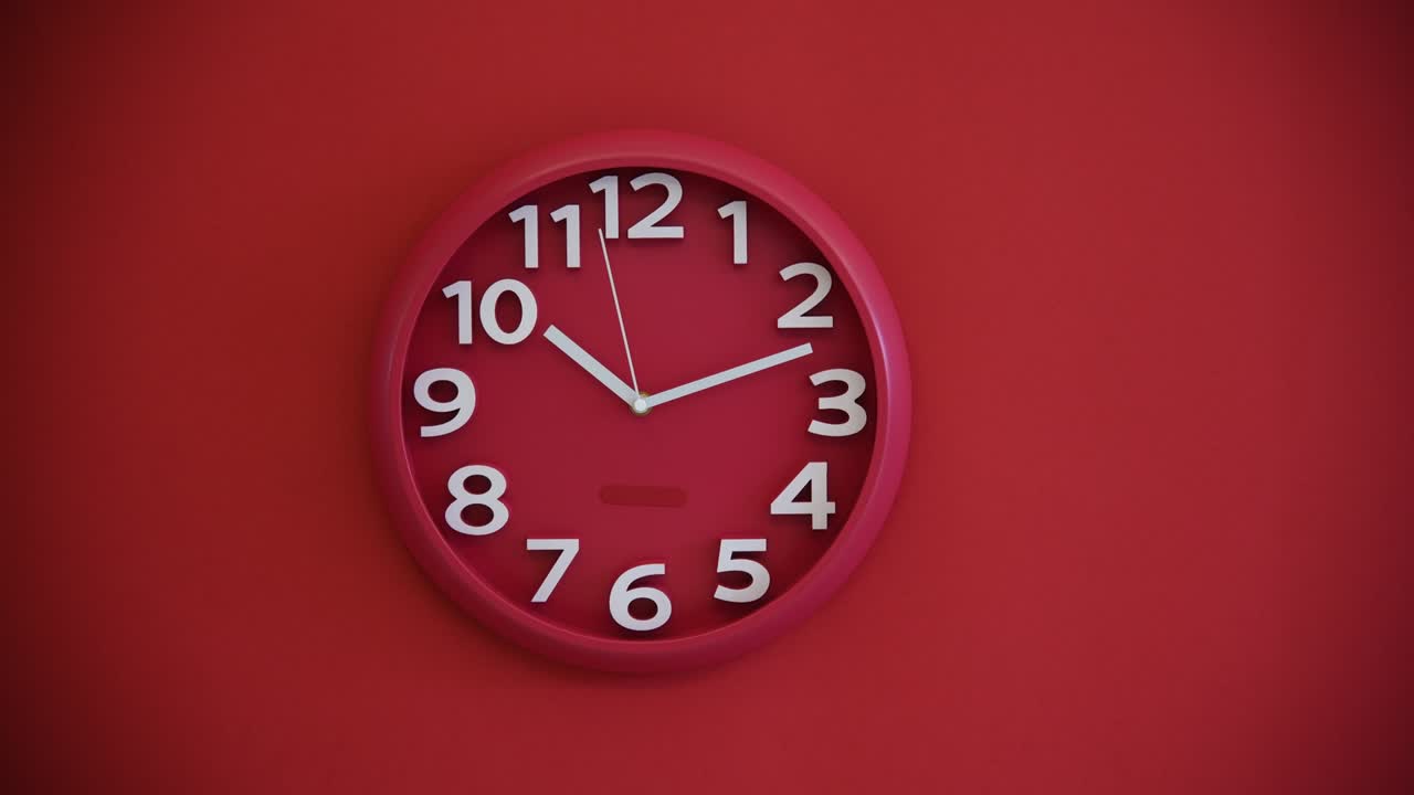Red wall clock on red background