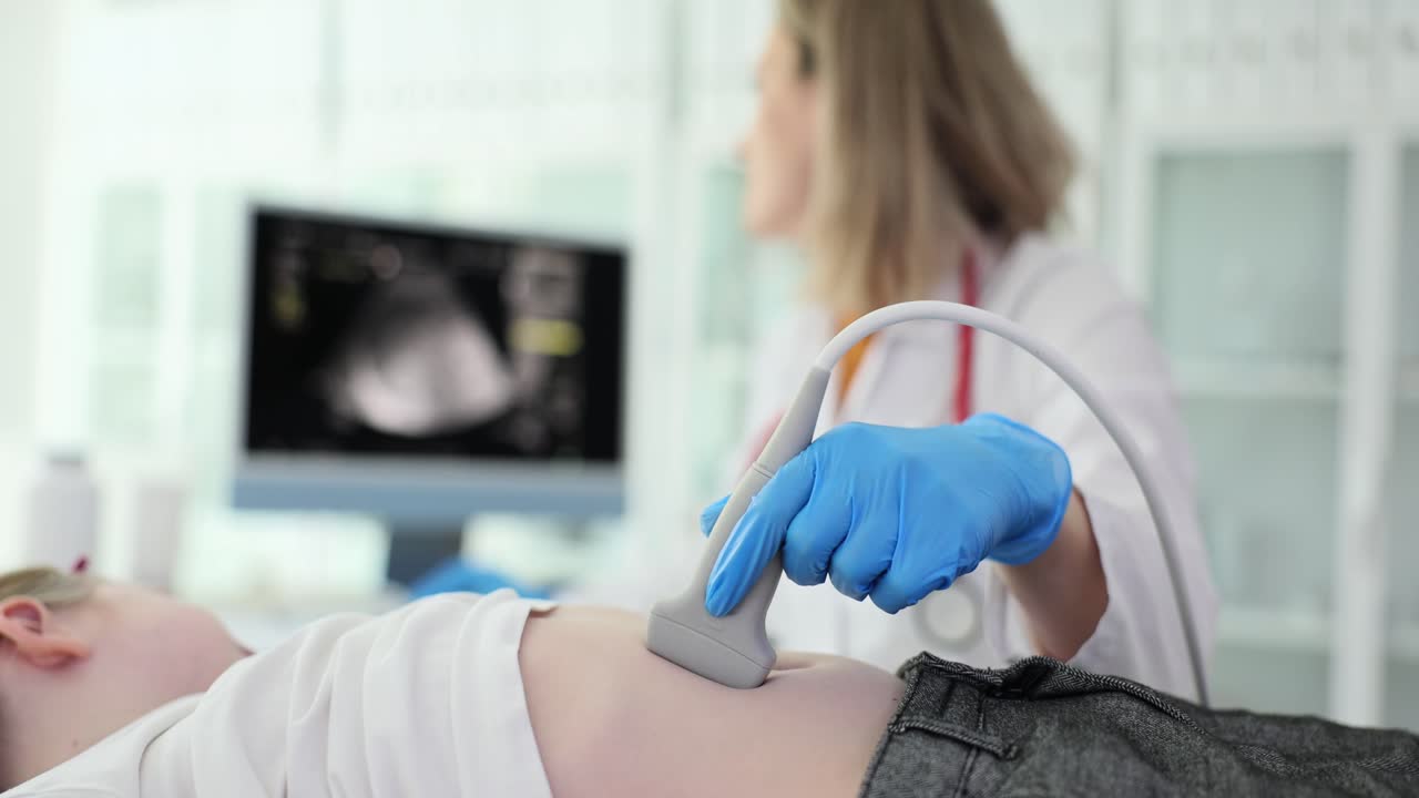 Doctor performing an ultrasound on a patient