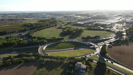 bustling-roundabout-set-against-Montpellier's-picturesque-backdrop-aerial