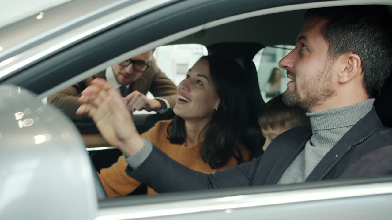 Family Test Driving a New Car at Dealership