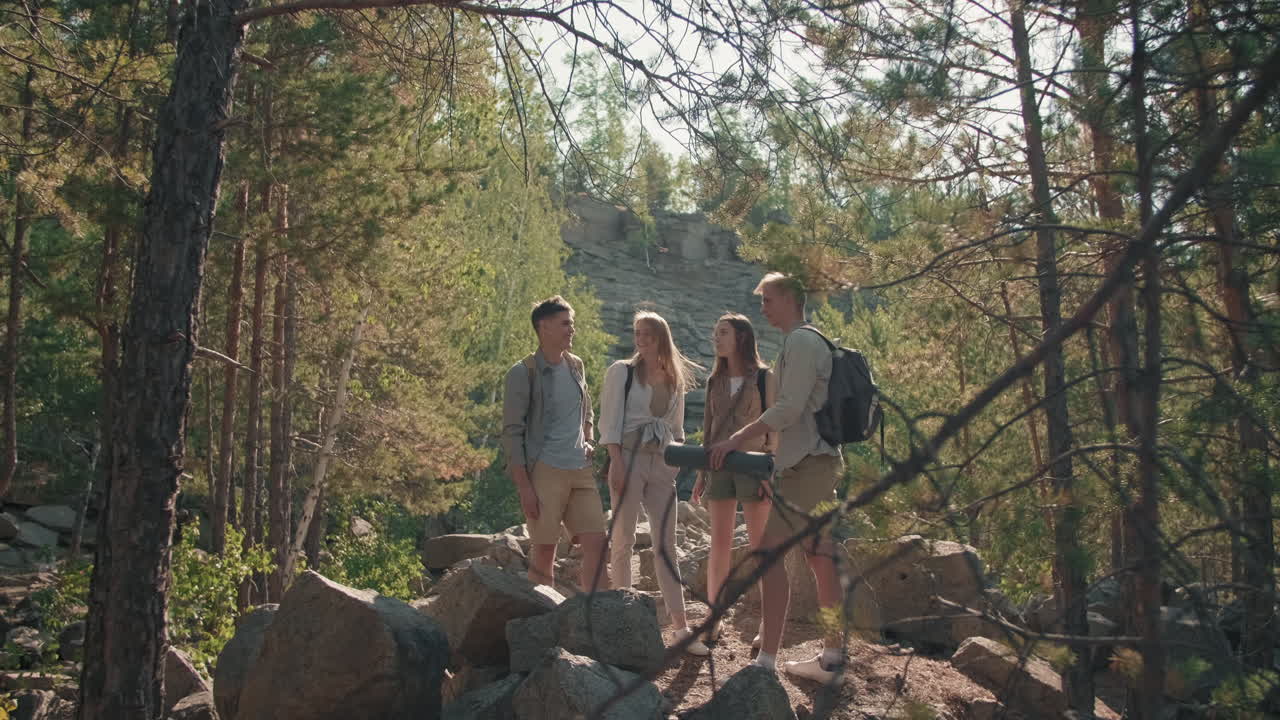 Young People Chatting on Hike in Woods