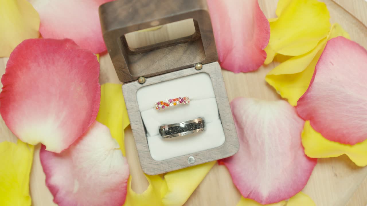revealing shot of his and her wedding rings in a box before the ceremony