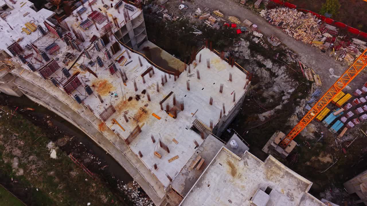 Construction site seen from above with workers and materials