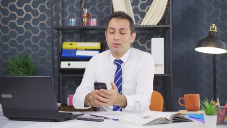 Dancing-happy-businessman-using-phone.