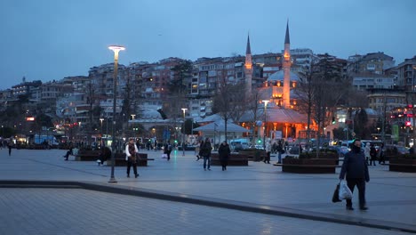 night scene in istanbul with mosque and people walking