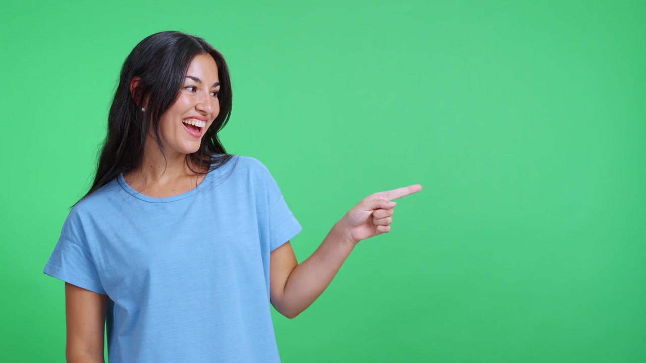 Happy Young Woman Pointing and Presenting on Green Screen
