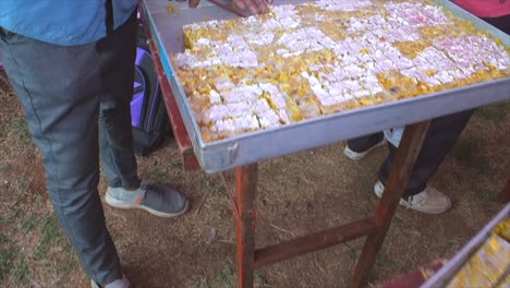 indian-sweets-making-and-sweets-placed-empty-rectangle-tray-closeup-view