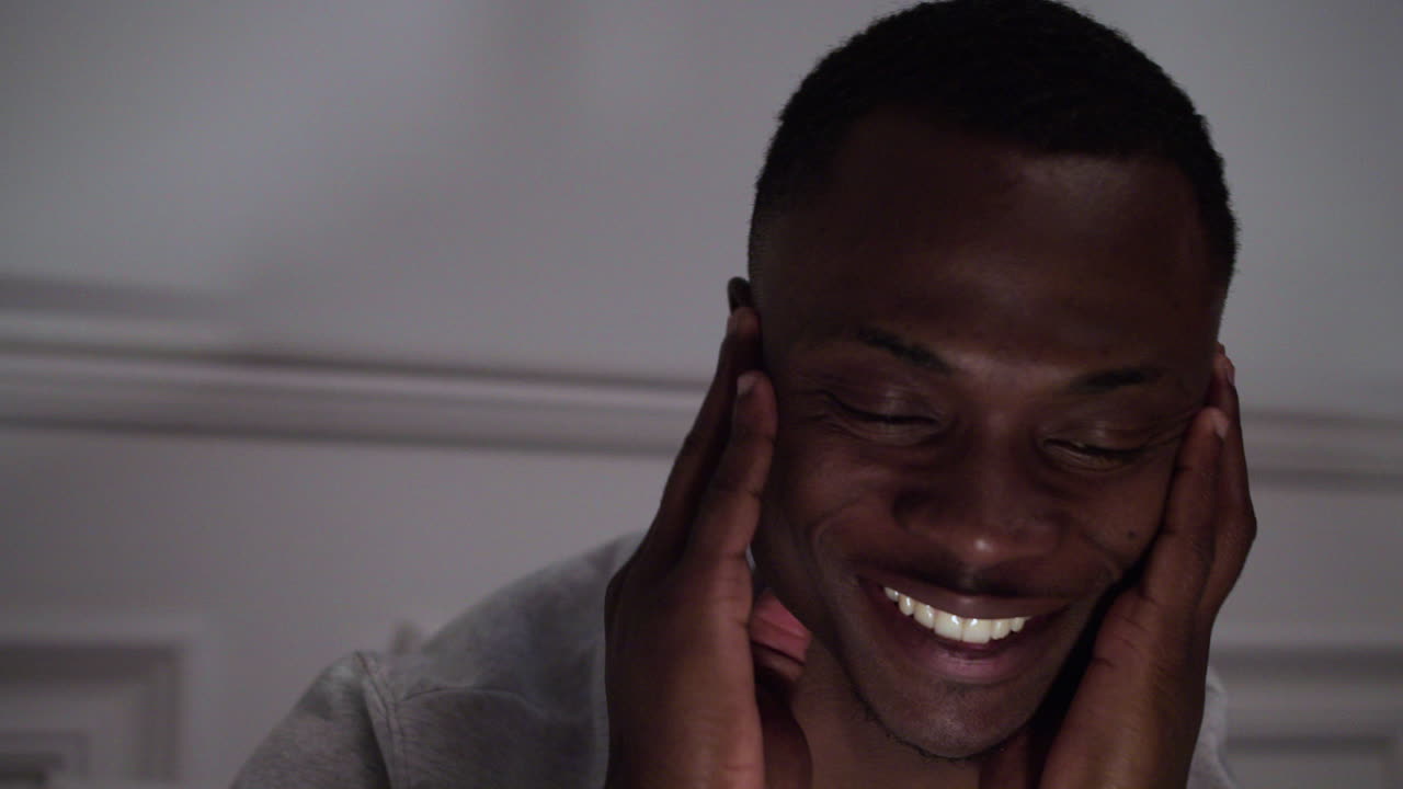 Closeup of young tired man on bed