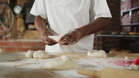 animation of hand of african american male baker preparing sourdough for bread