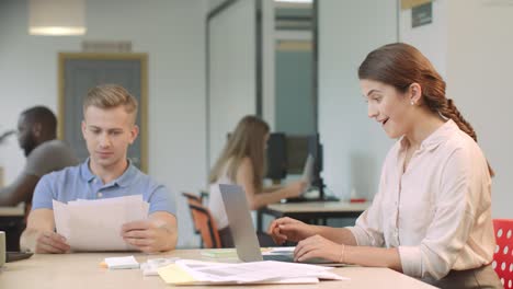 business woman looking at laptop computer in office. happy woman reading news