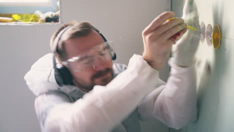 Marido-Con-Gafas-Recibe-Una-Descarga-Eléctrica-Reparando-Un-Enchufe-En-La-Habitación