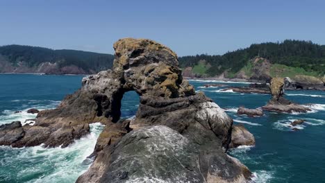 an orbiting drone shot, rotating around an isolated sea mount, off the oregon coast in the pacific northwest