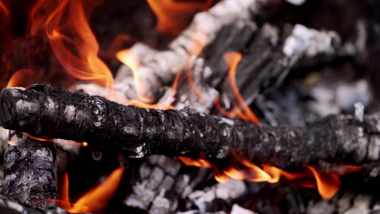 Firewood in flame close up. Detailed close up of warm fire with tongue of flame