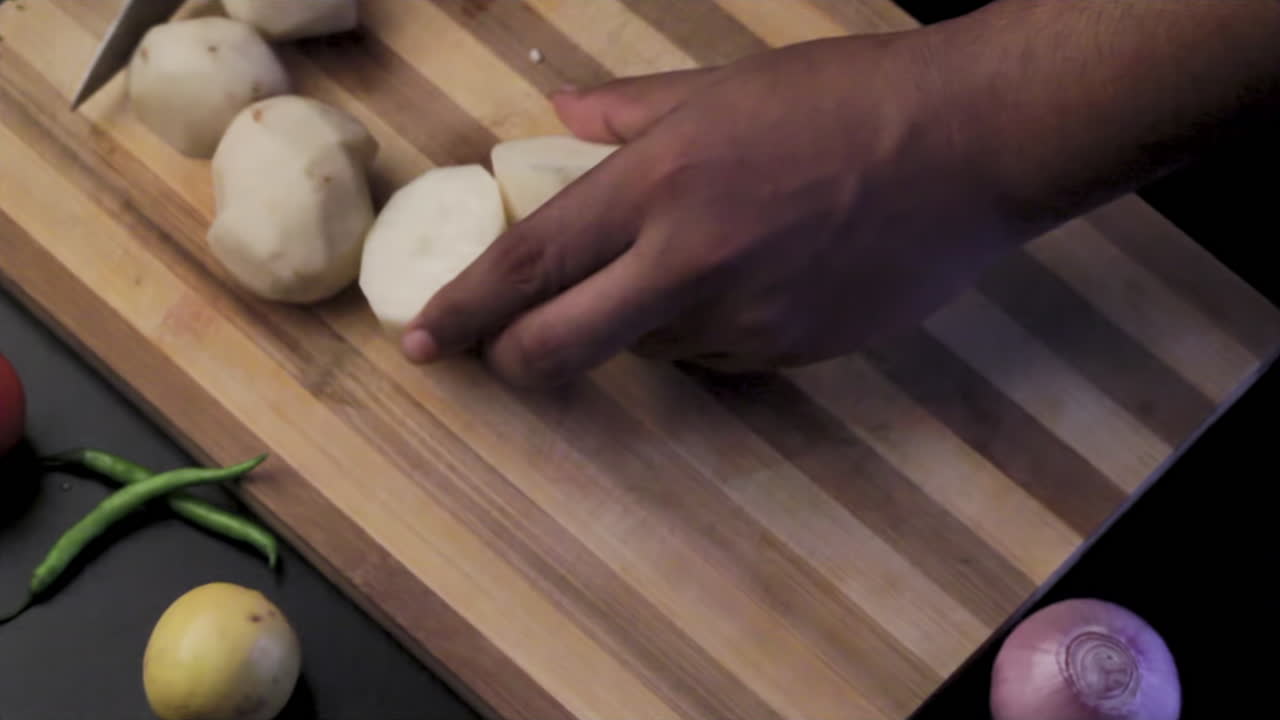 WHOLE POTATO CUTTING INTO HALF INSIDE THE KITCHEN