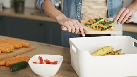 Static-video-of-woman-throwing-organic-waste-in-the-kitchen