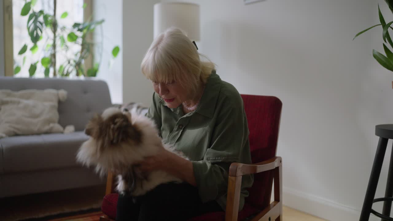 A senior woman holding her dog