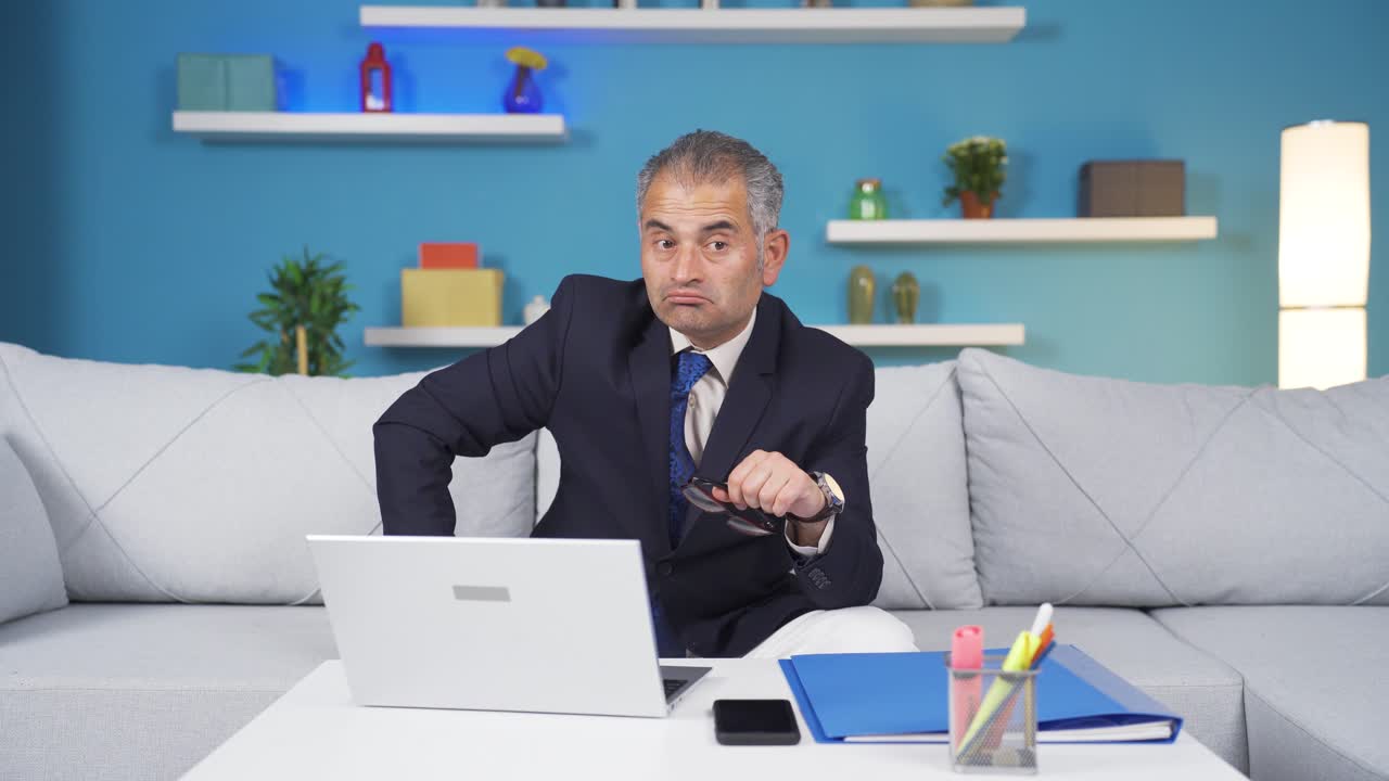 Home office worker man looking at camera confused.