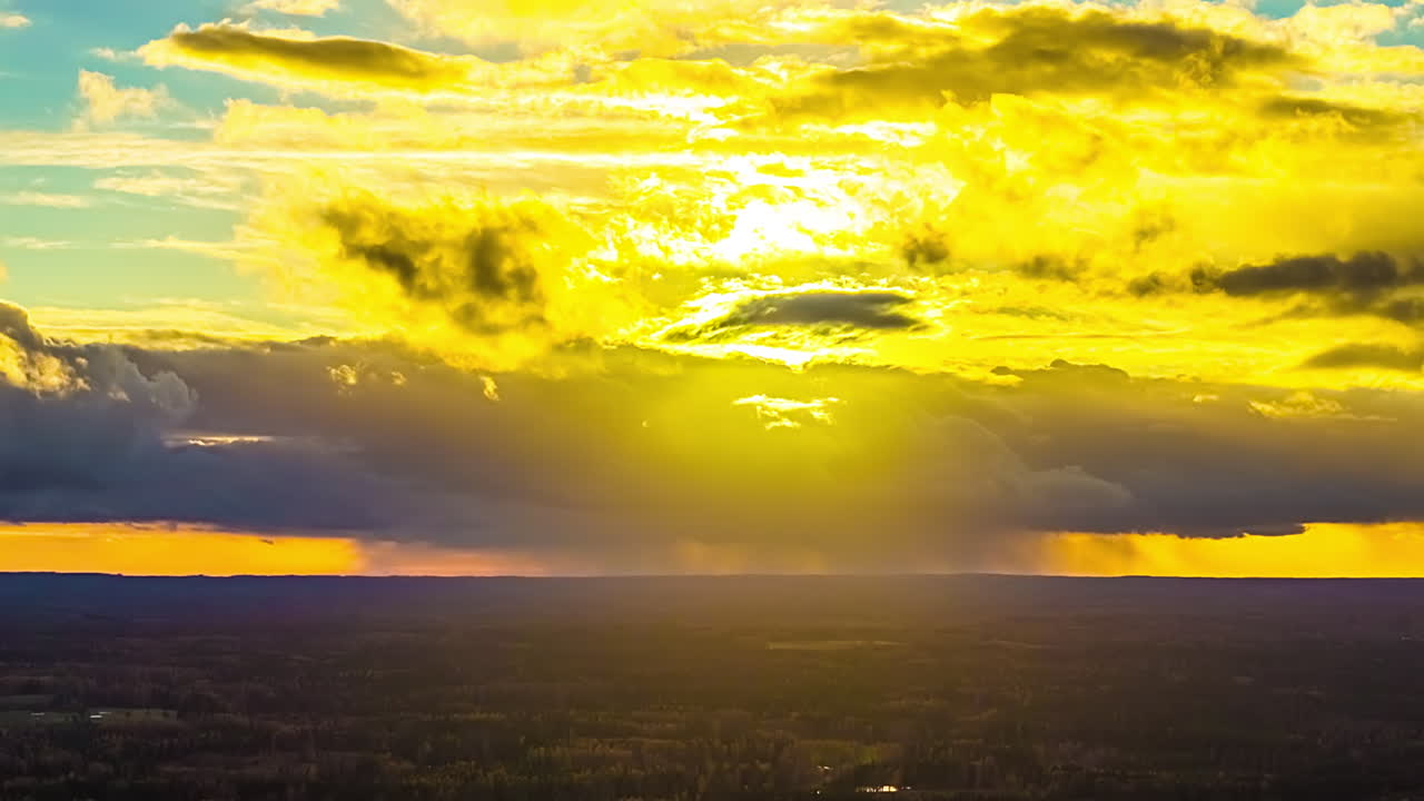 Golden sunset time lapse moving cloud layer as sunlight light yellow over horizon