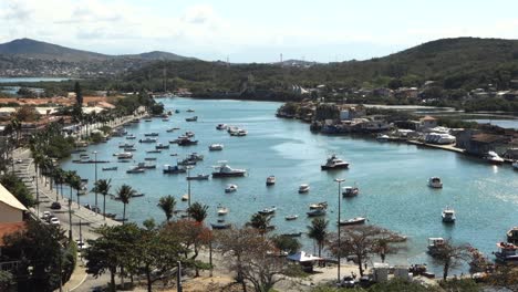 fishing boats and yachts moored at calm waters of araruama lagoon channel in cabo frio, brazil