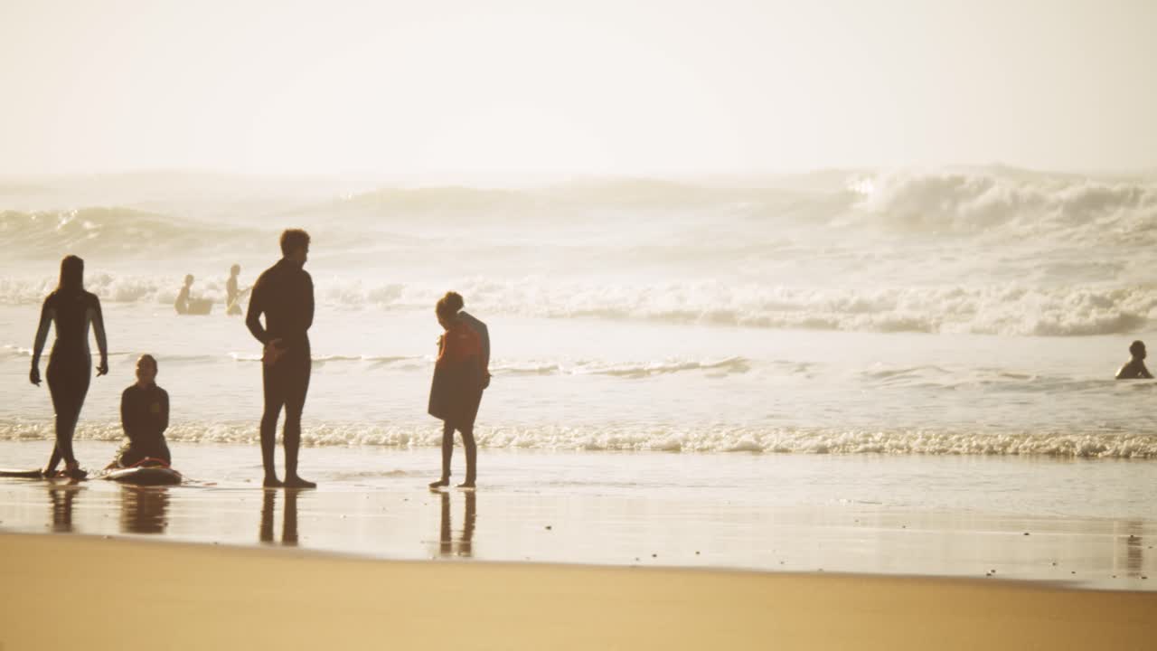 A warming misty summery scene with a family enjoying time on the beach together