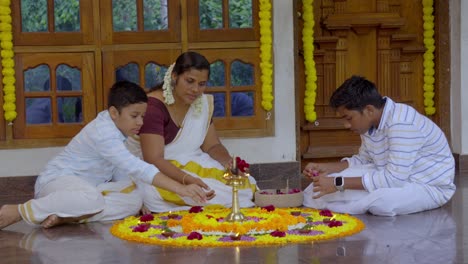 athapookkalam decorating for onam festival in kerala ,pookalam decorating kerala traditional family for onam celebration