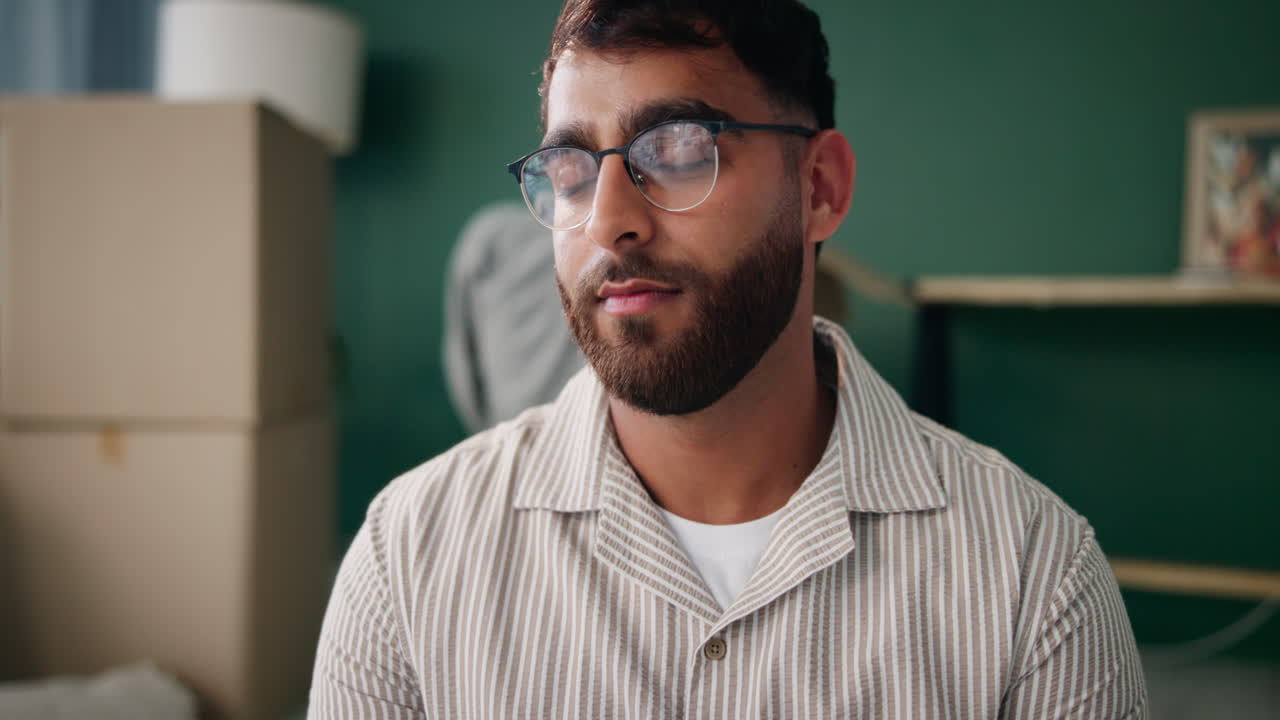 Man with Glasses and Beard in Front of Boxes
