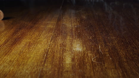 closeup of 1 euro cent coin flipping on wooden table, static, slow