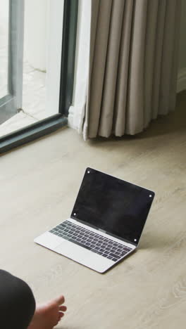 video of plus size african american woman practicing yoga with laptop with copy space