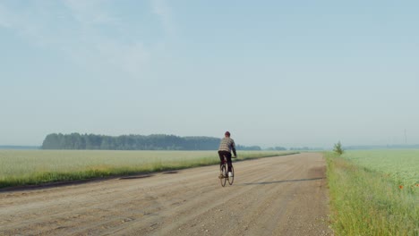 cyclist on a country road at dawn