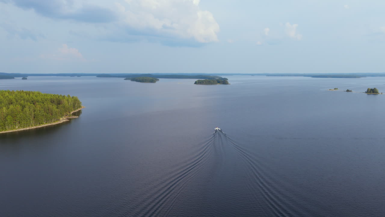Drone following a boat on Rauvitsanselka at lake Puruvesi, summer in Finland
