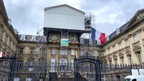 french flag waving with wind on the gate