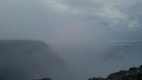 flowing clouds and mist in the wind at north cape, norway