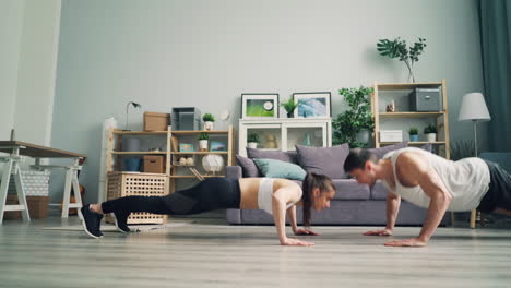 couple doing push-ups at home