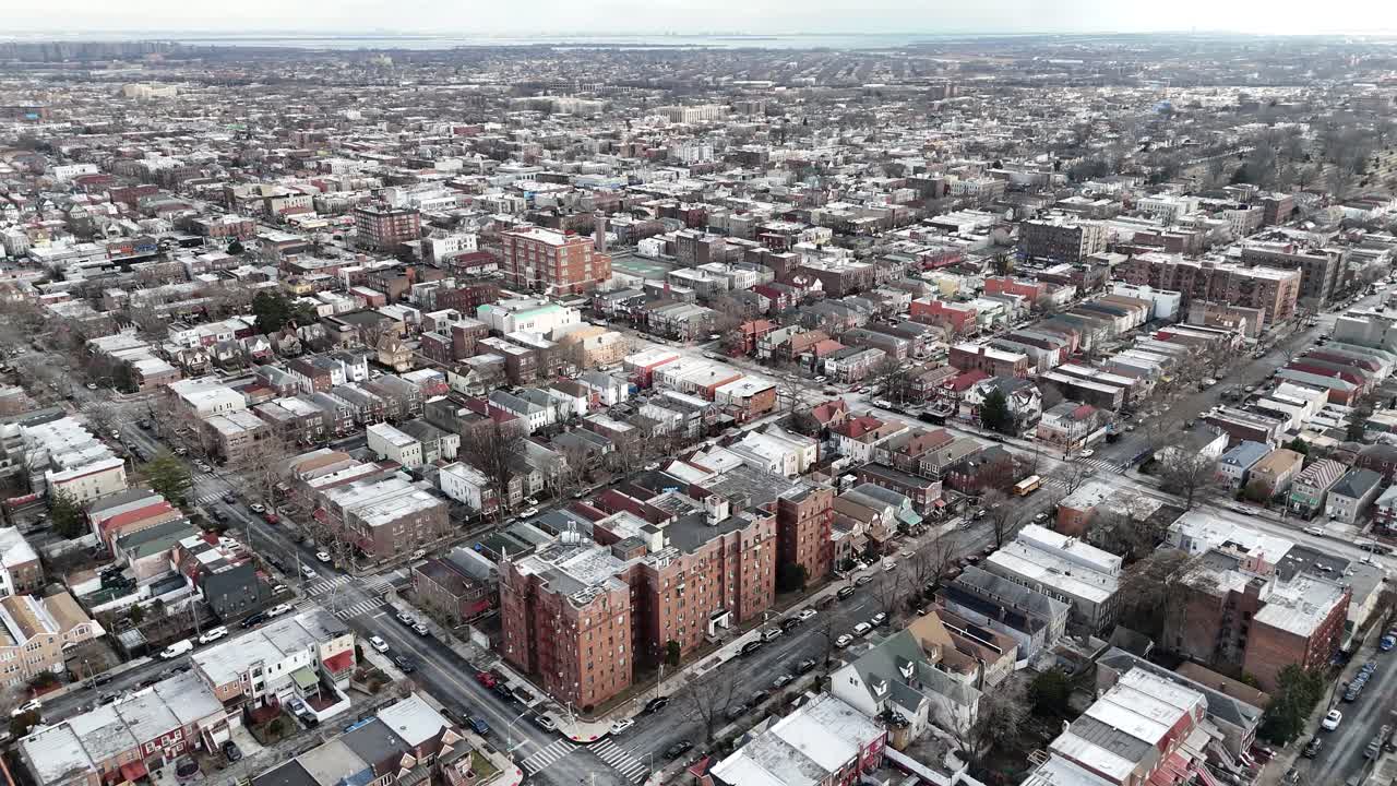 Horizontal drone fly-around shot over Troy Ave, Brooklyn, capturing New York’s dynamic cityscape, vibrant rooftops, and urban charm with a smooth aerial perspective.