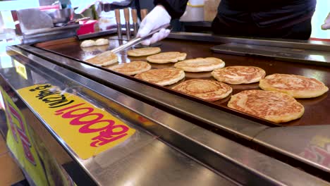 a food vendor in korea making hotteok