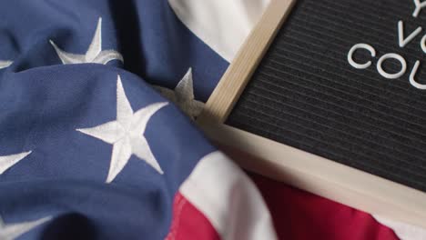 close up of sign reading your vote counts lying on us stars and stripes flag for american election 2024