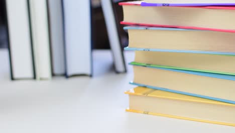 desk with stack of study books. textbooks for the student, university. study from home. distance education concept.